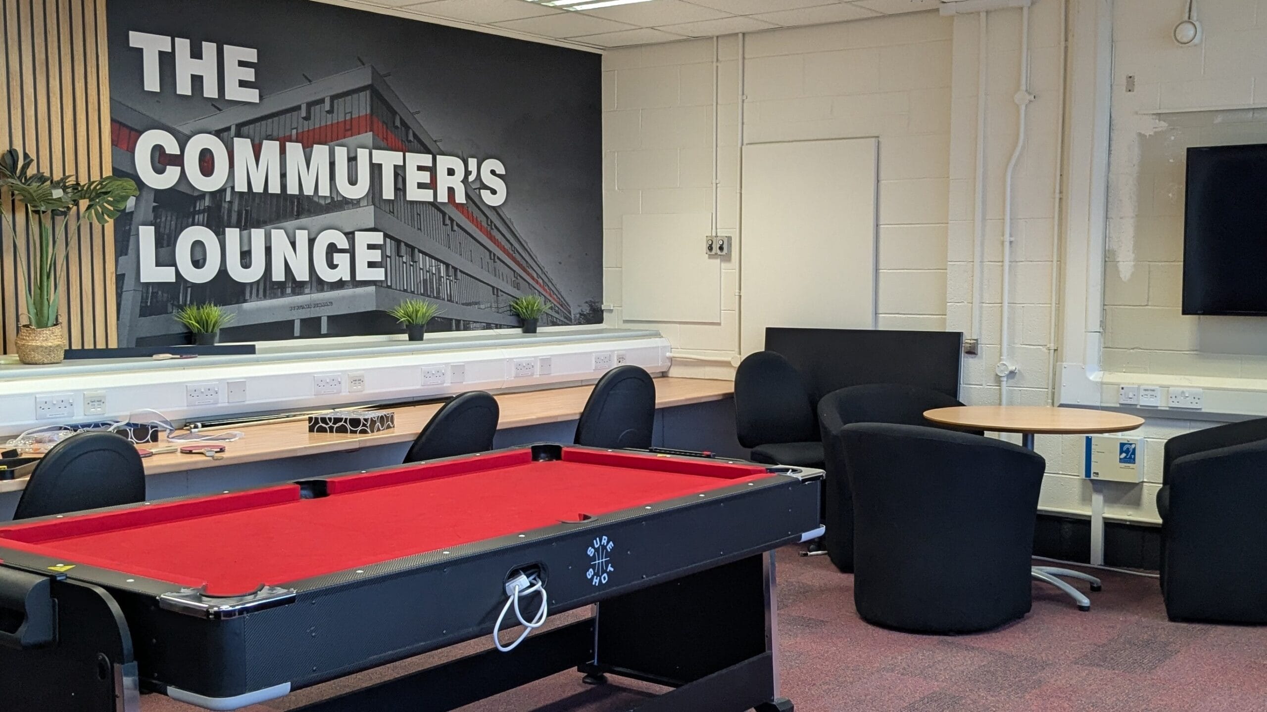 Image of a commuter students lounge with a pool table and study spaces