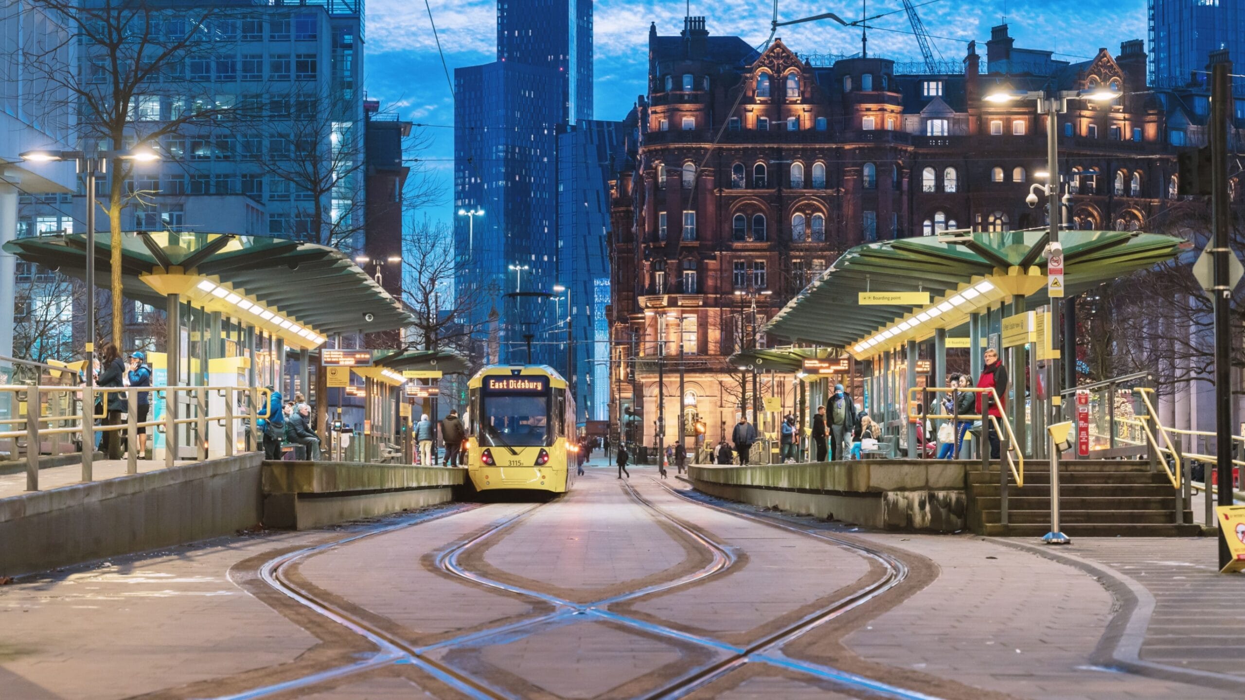 Image of a yellow Bee Network tram in Manchester city centre