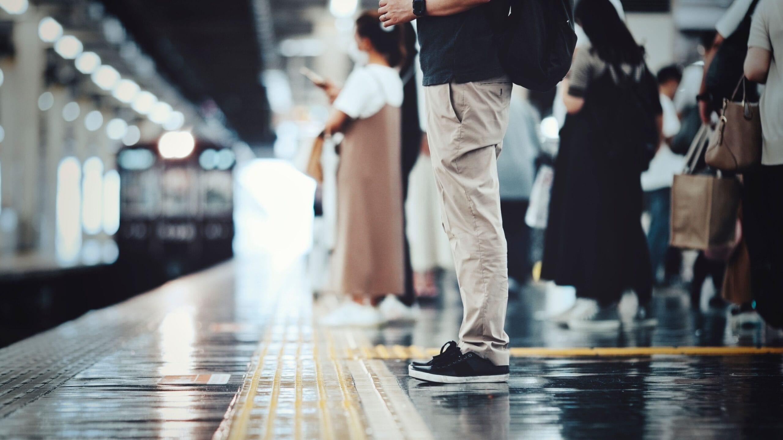Image of people stod waiting for a train from a low angle