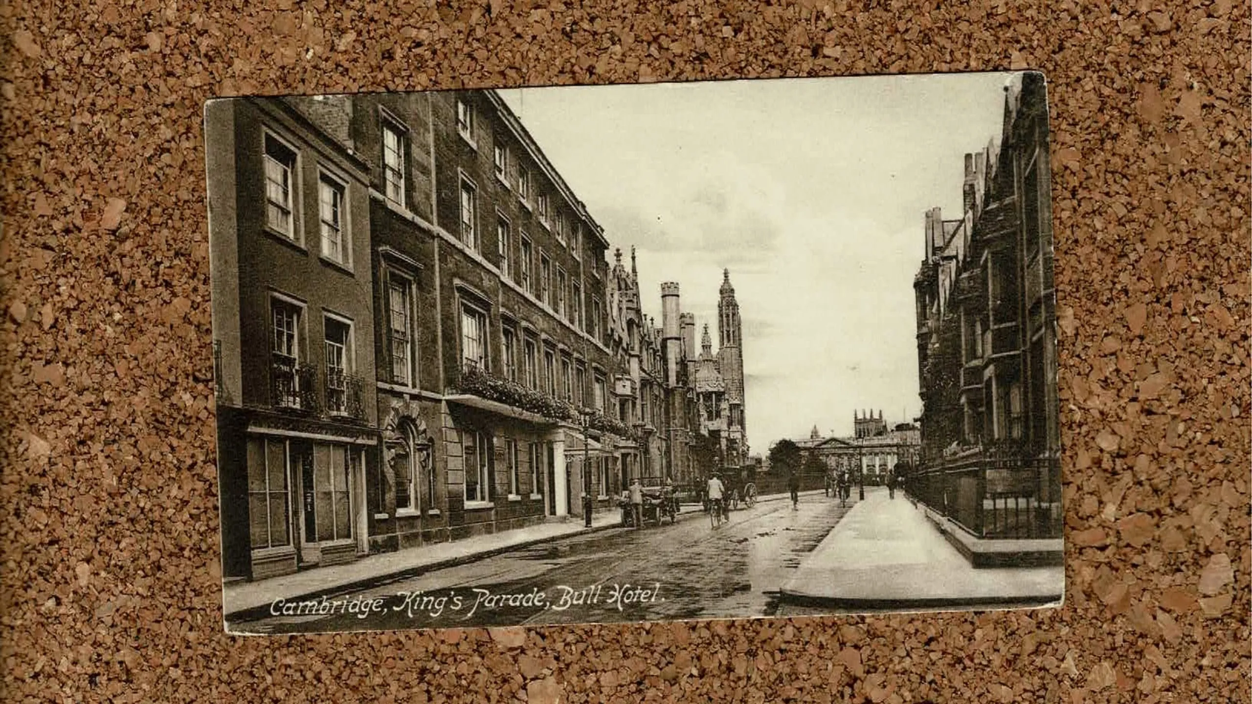 Image of a postcard of Bull College on a cork background