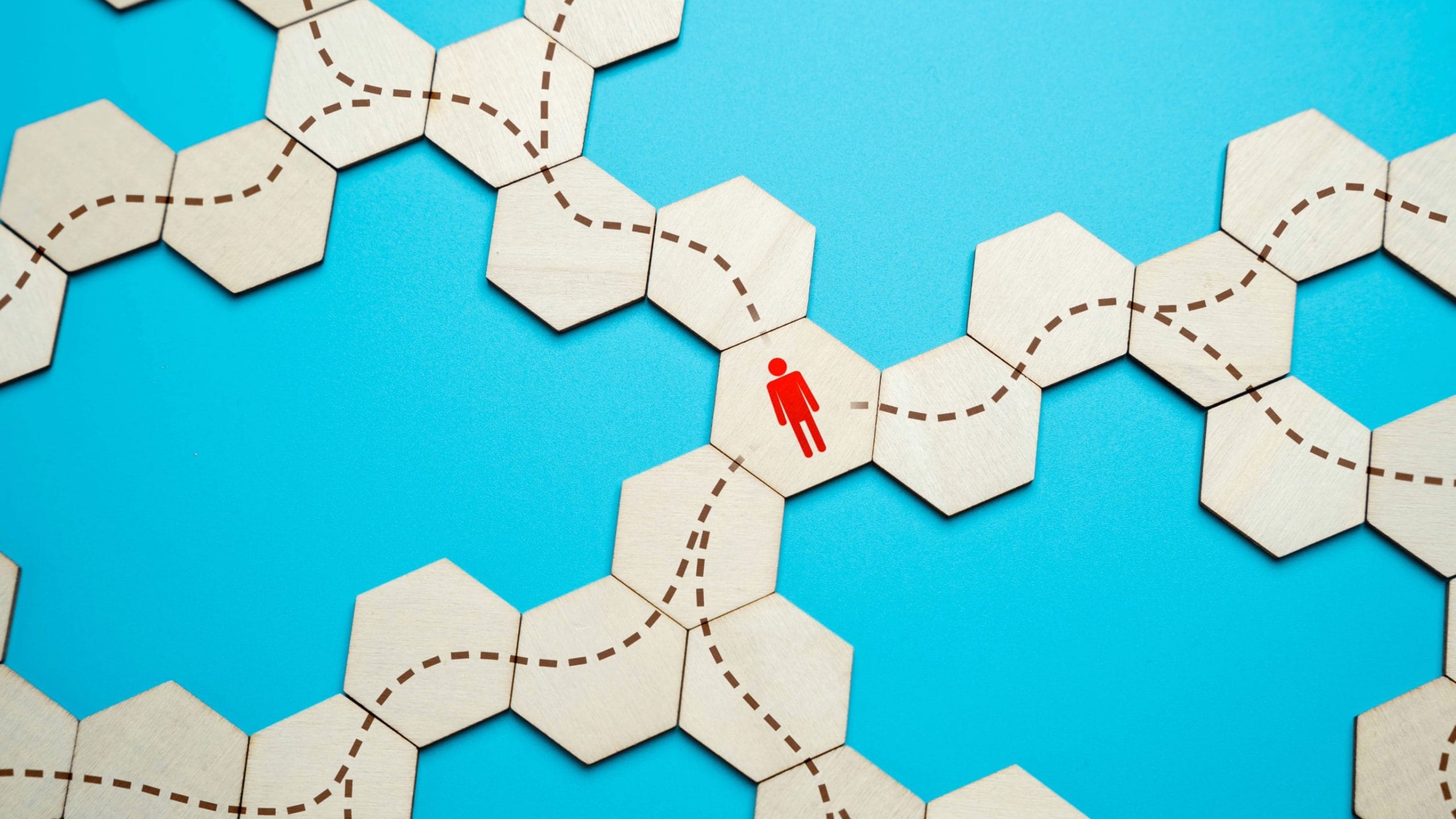 Image of lots of hexagons connected with various pathways and a person icon deciding which one to choose.