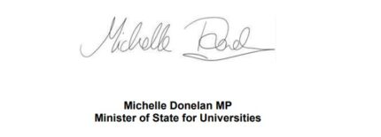 Michelle Donelan signs a letter.