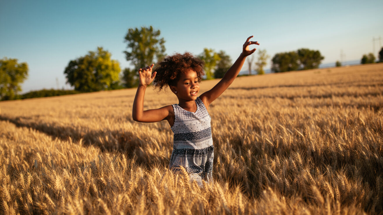 Carefree,And,Playful,Girl,Running,Through,The,Wheat,Field.