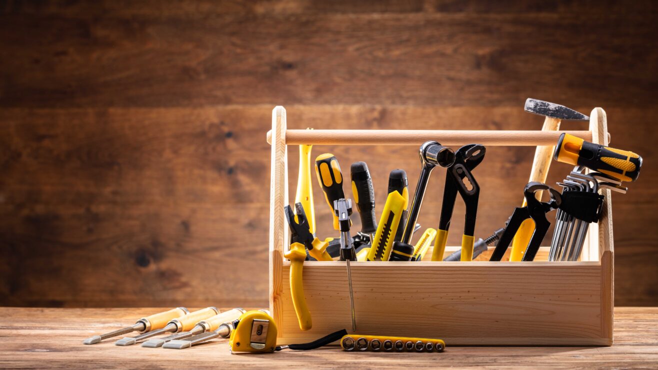 Toolbox,With,Various,Worktools,On,Wooden,Surface