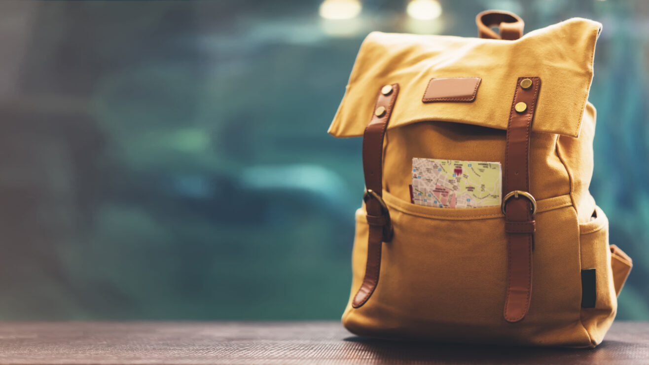 Hipster,Yellow,Backpack,And,Map,Closeup.,View,From,Front,Tourist