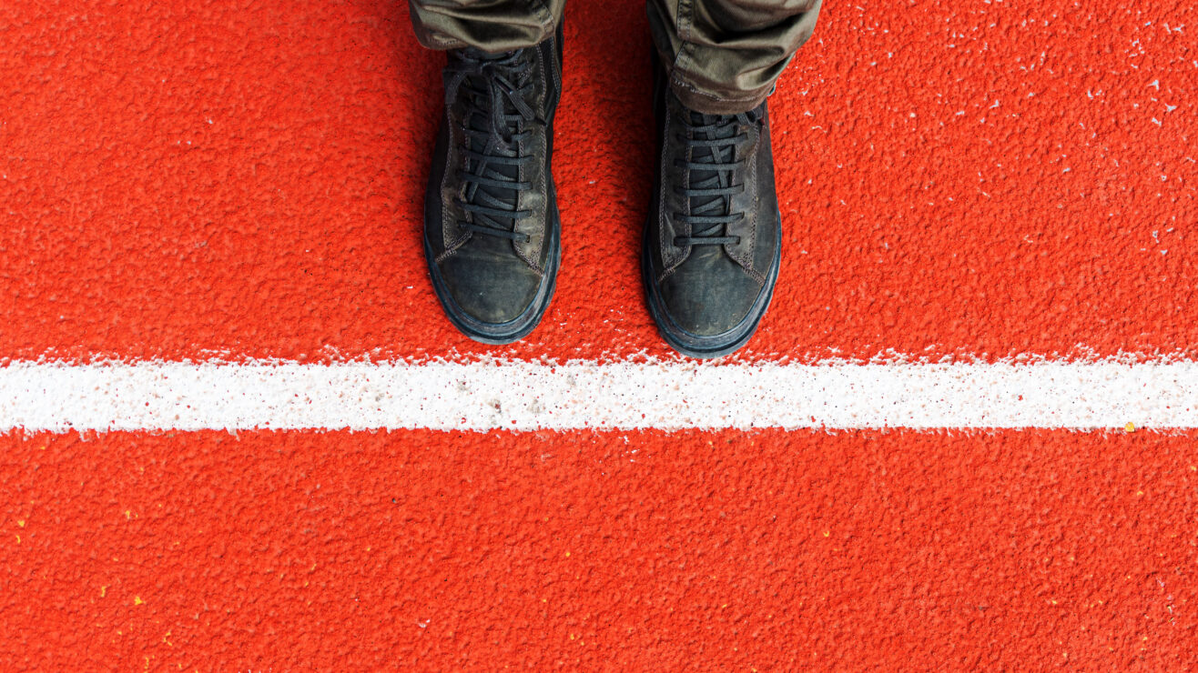 Top,View,Of,Dirty,Male,Boots,Standing,Next,To,The