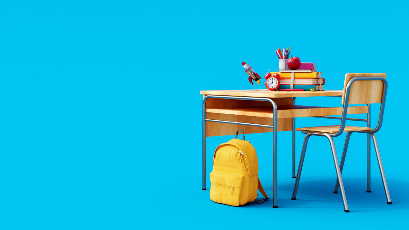 School,Desk,With,School,Accessory,And,Yellow,Backpack,On,Blue