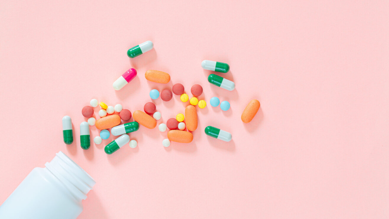 Pills,And,Pill,Bottles,On,Pink,Background,assorted,Pharmaceutical,Medicine,Pills,