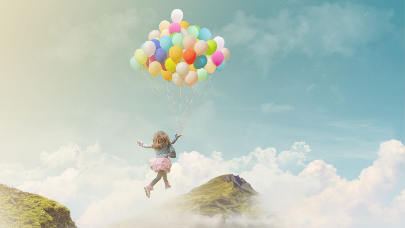 Little,Girl,Holding,Colorful,Balloons,,Jumping,From,One,Mountain,Top