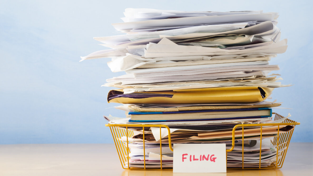 An,Old,Yellow,Wireframe,Filing,Tray,,Piled,High,With,Documents