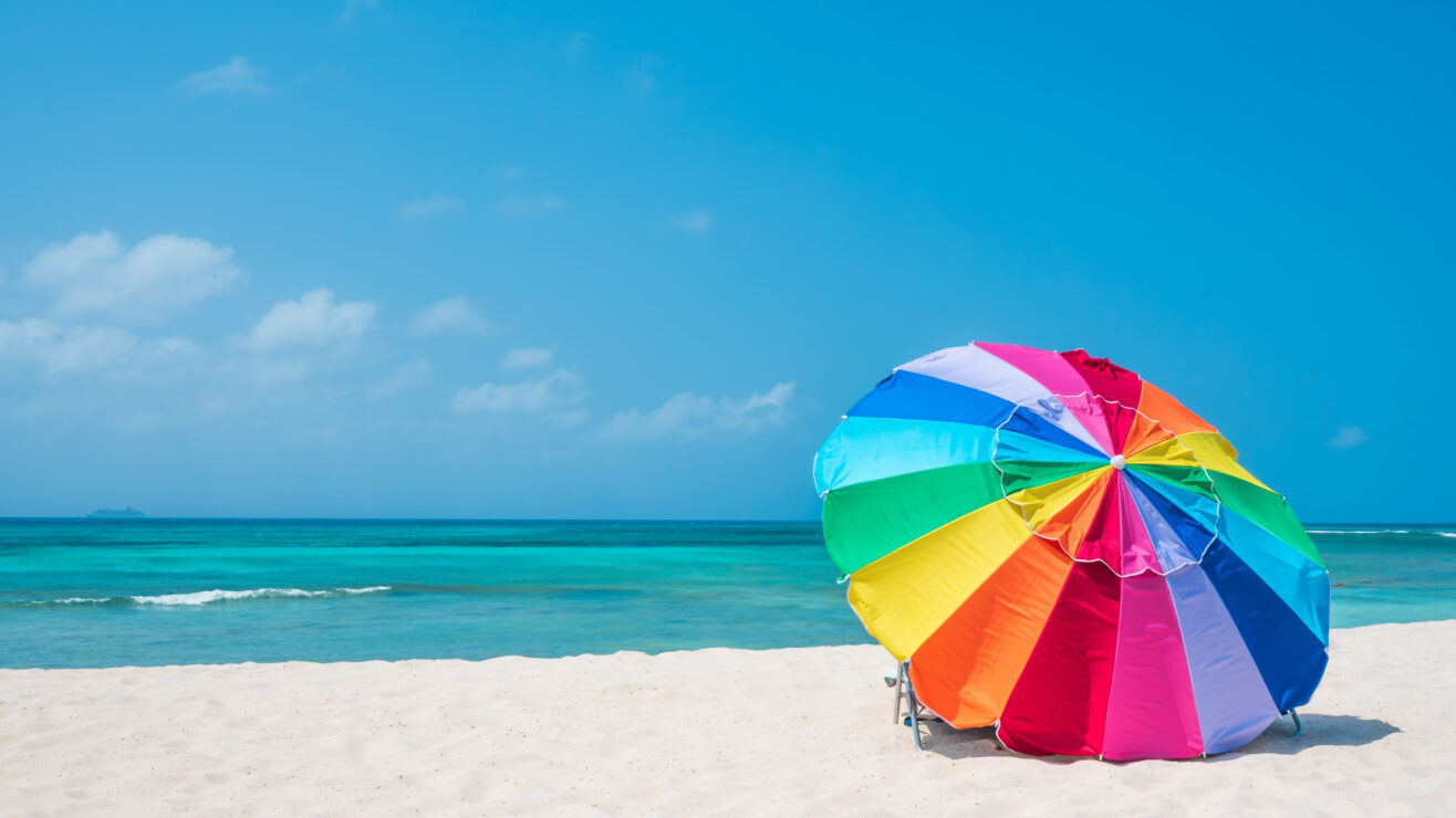 Multicolour,Vibrant,Rainbow,Beach,Umbrella,On,A,Beautiful,Hot,And